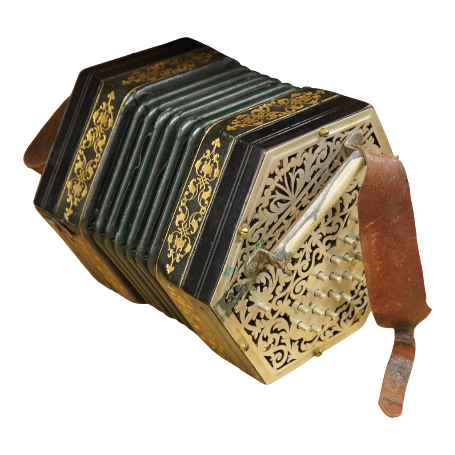 A Jeffries hexagonal concertina with pierced silvered metal ends, and gilt tooled leather bellows, maker’s mark stamped to the metal work on one end